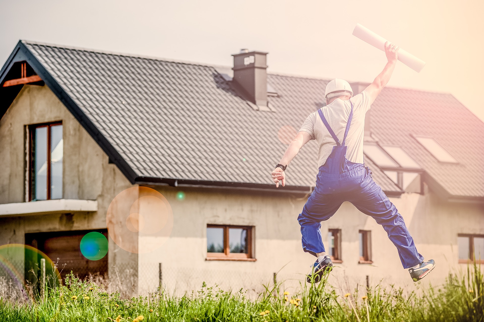 a man jumping in front of the house